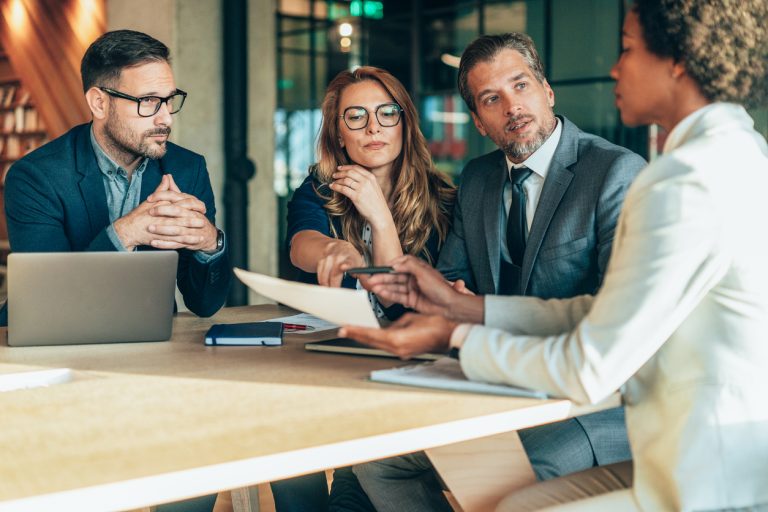 Group of business persons in business meeting. Group of entrepreneurs on meeting in board room. Corporate business team on meeting in the office. Multiracial group of business people having discussion
